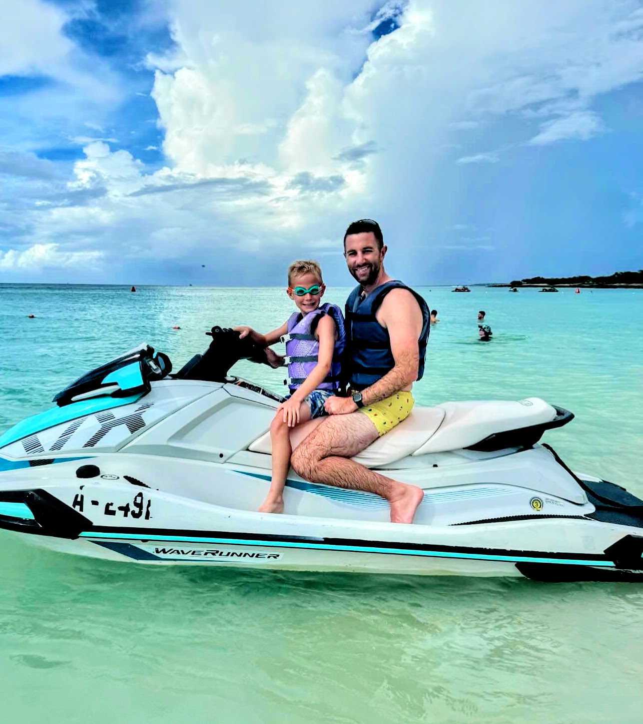 Preston Mitchell on a jet ski with his son